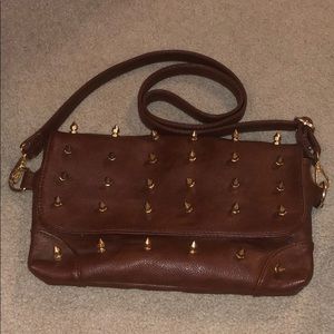 spiked brown purse with floral interior